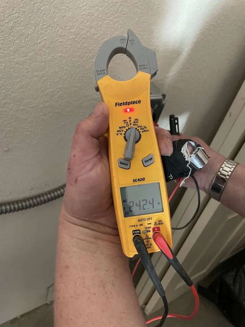 Voltage testing with clamp meter during Outlet Installation in Brecknock